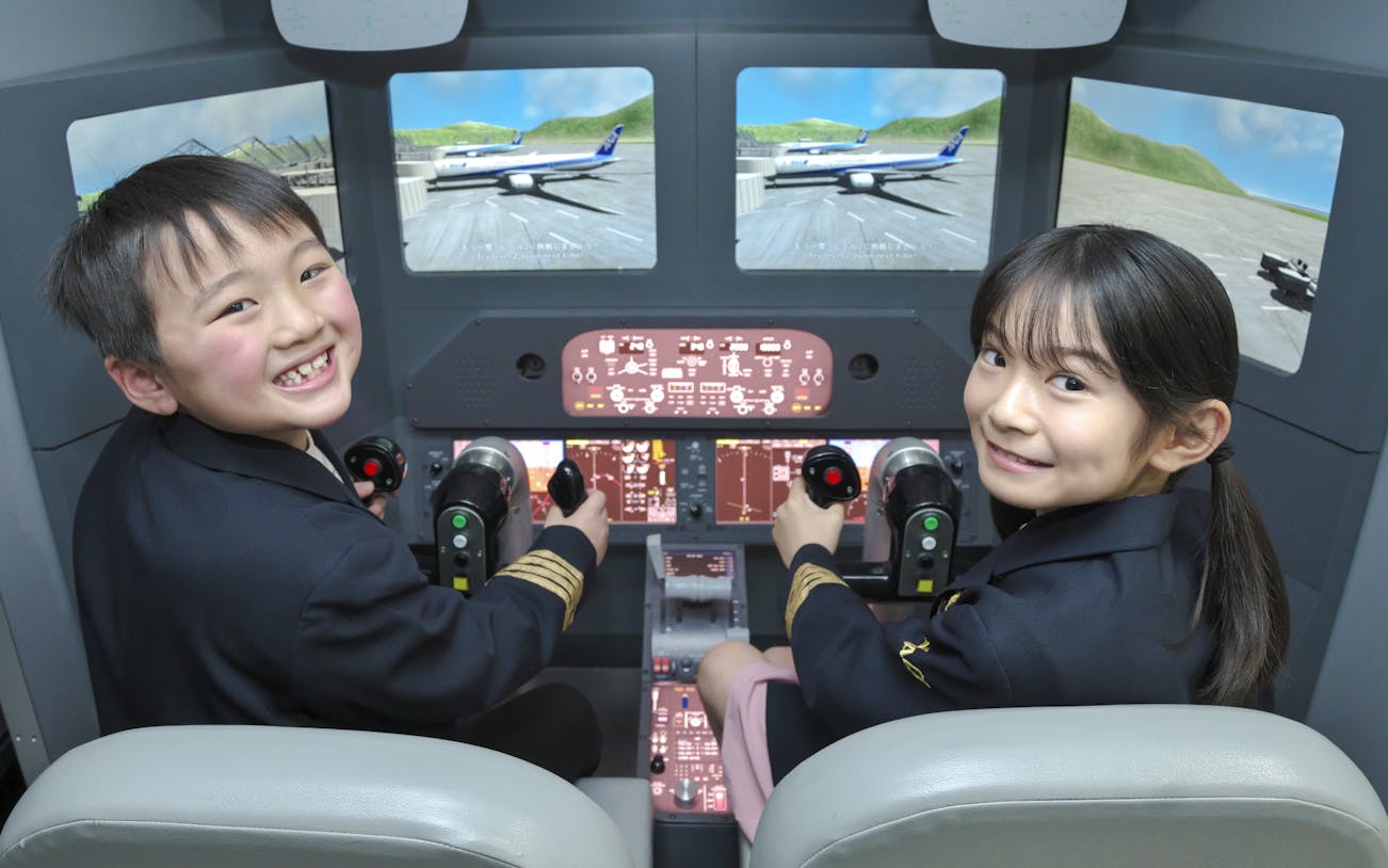 Young pilots in a flight simulator at Kidzania Tokyo.