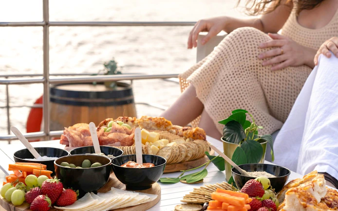 Grazing platter with fruits and cheese on a Sydney Harbour sunset cruise.
