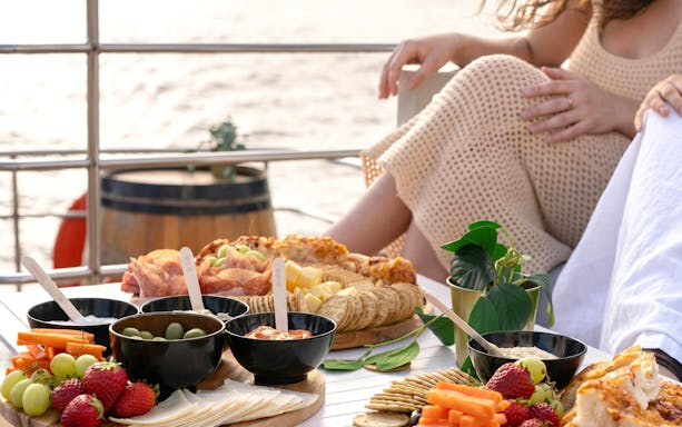 Grazing platter with fruits and cheese on a Sydney Harbour sunset cruise.