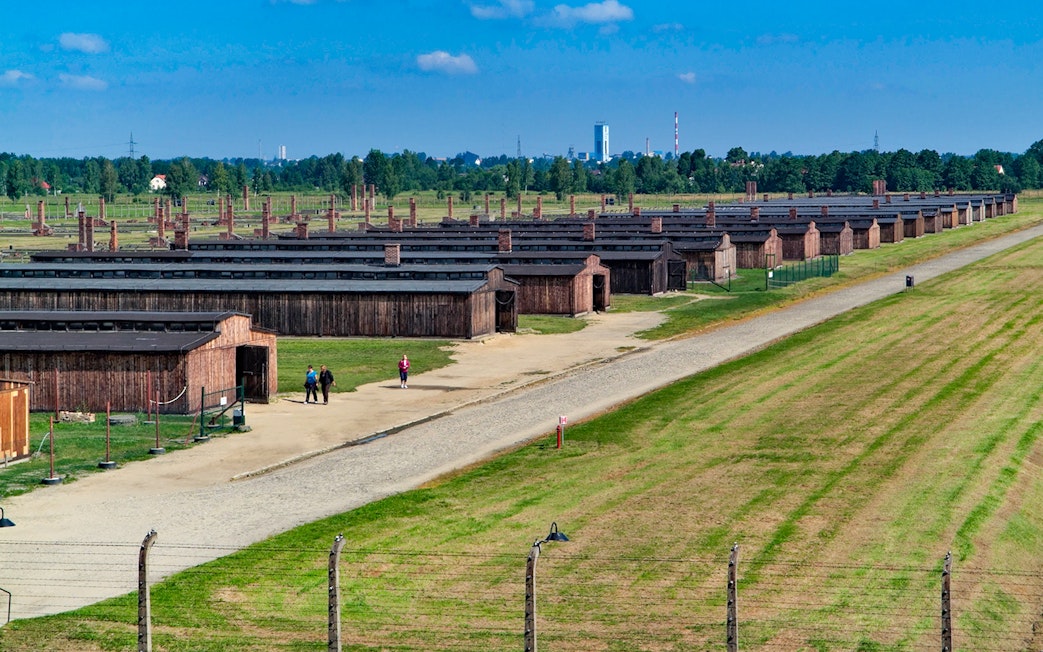 Aerial view of Auschwitz Birkenau with barracks and pathways visible.