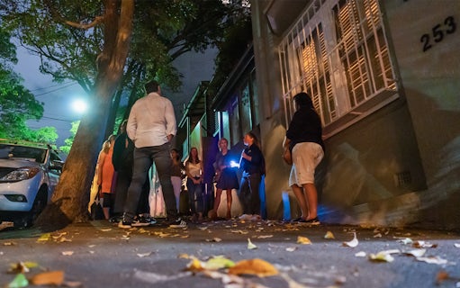 Group on Sydney's Razor Gang True Crime Tour at night on a dimly lit street.