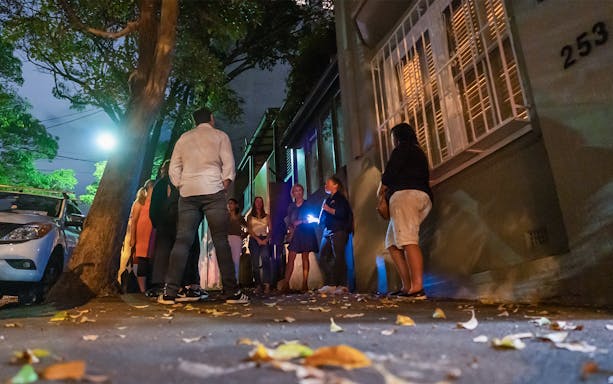 Group on Sydney's Razor Gang True Crime Tour at night on a dimly lit street.