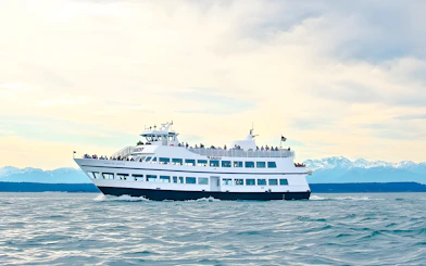 Argosy Cruises vessel on Seattle Locks cruise with mountains in the background.