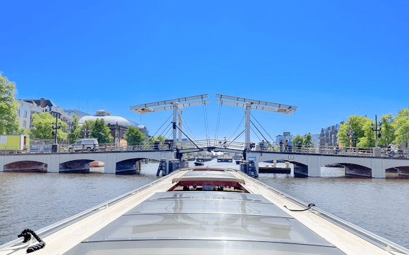 Boat approaching Amsterdam's Magere Brug on a canal cruise.