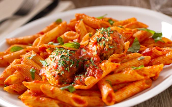 Pasta with meatballs served at the Speakeasy Murder Mystery Dinner Show in Orlando.