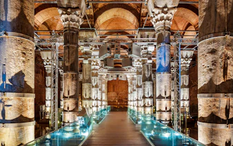 Illuminated columns inside Theodosius Cistern, Istanbul, showcasing ancient architecture.