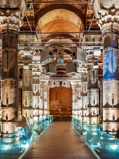 Illuminated columns inside Theodosius Cistern, Istanbul, showcasing ancient architecture.