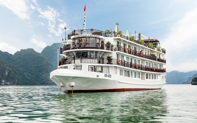 Emotion Cruise ship on Halong Bay with limestone karsts in the background.