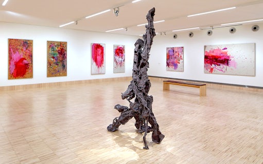 Sculpture by Albert Oehlen inside ALBERTINA KLOSTERNEUBURG gallery with abstract paintings.