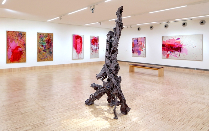 Sculpture by Albert Oehlen inside ALBERTINA KLOSTERNEUBURG gallery with abstract paintings.