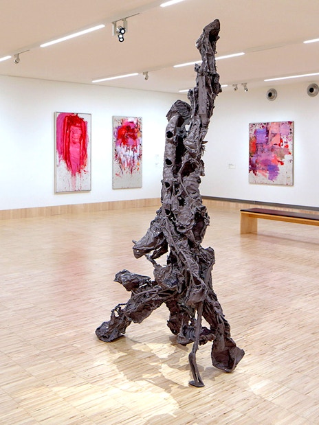Sculpture by Albert Oehlen inside ALBERTINA KLOSTERNEUBURG gallery with abstract paintings.