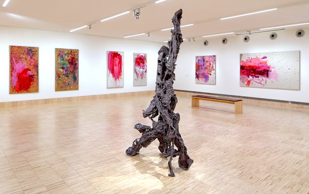 Sculpture by Albert Oehlen inside ALBERTINA KLOSTERNEUBURG gallery with abstract paintings.