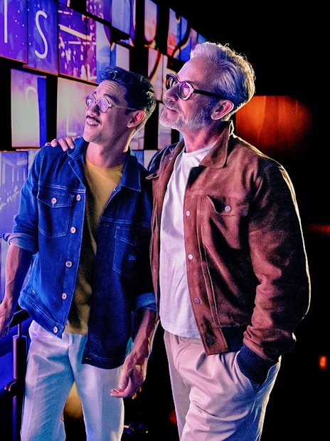 Visitors at Welcome Grid, One World Observatory entrance, New York City skyline images displayed.