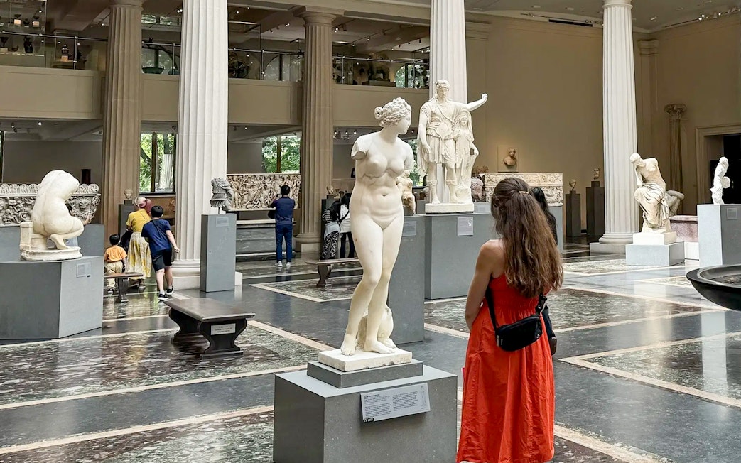 Visitors exploring sculptures at The Met Museum during a pre-orientation tour.