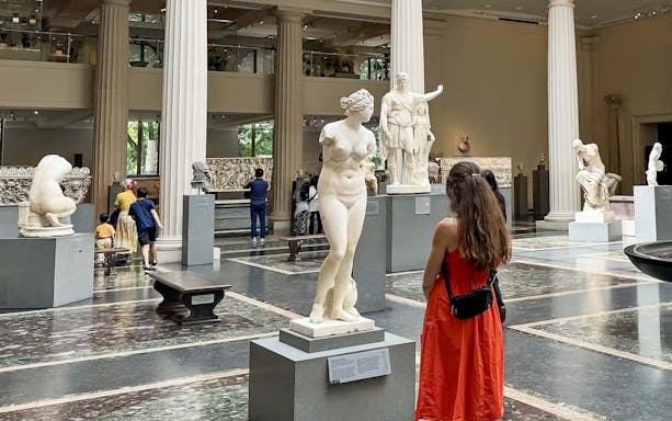 Visitors exploring sculptures at The Met Museum during a pre-orientation tour.