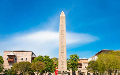 Obelisk of Theodosius in Istanbul's Old City with surrounding buildings.