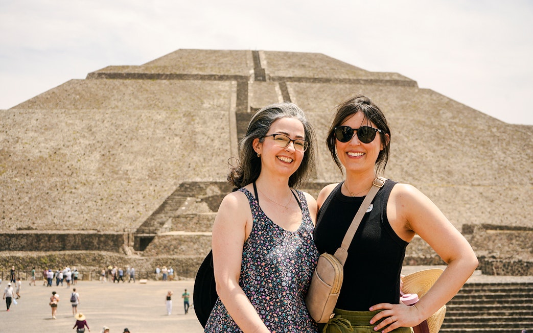 Visitors at Pyramid of the Moon, Teotihuacan, with the ancient structure in the background.