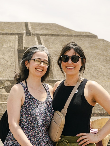 Visitors at Pyramid of the Moon, Teotihuacan, with the ancient structure in the background.