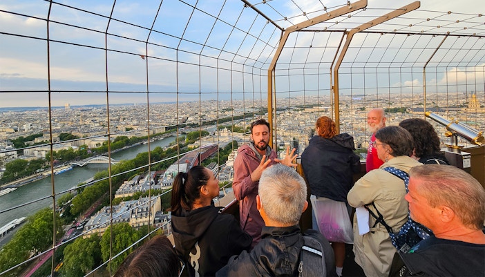 Tourists with guide on second floor of Eiffel Tower