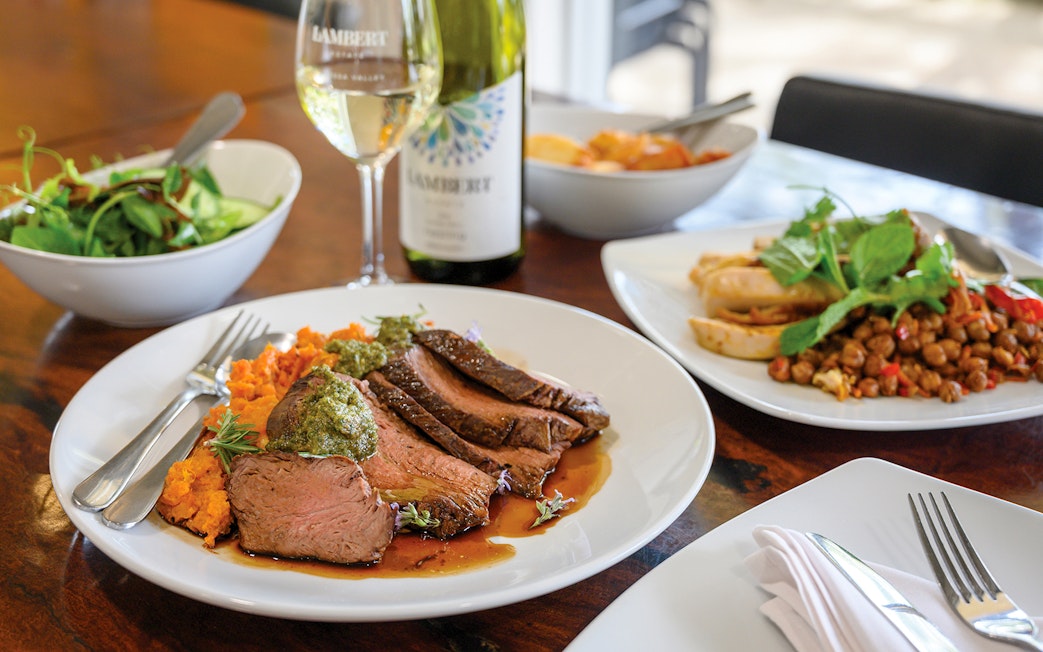 Barossa Food and Wine Experience with lamb, sweet potato mash, and wine on a dining table.