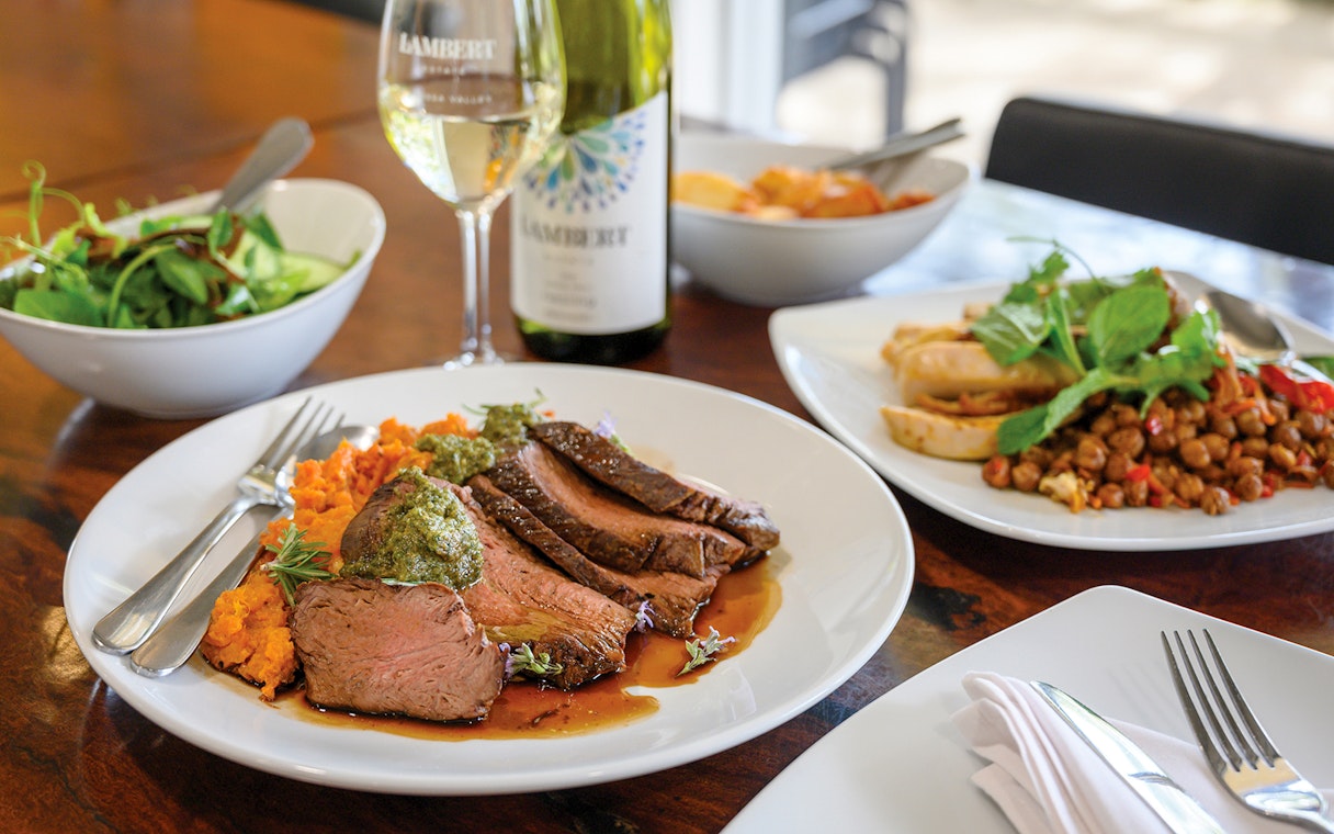 Barossa Food and Wine Experience with lamb, sweet potato mash, and wine on a dining table.
