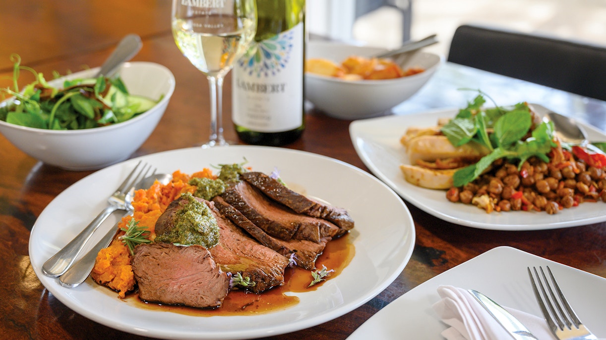 Barossa Food and Wine Experience with lamb, sweet potato mash, and wine on a dining table.