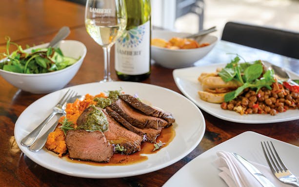 Barossa Food and Wine Experience with lamb, sweet potato mash, and wine on a dining table.