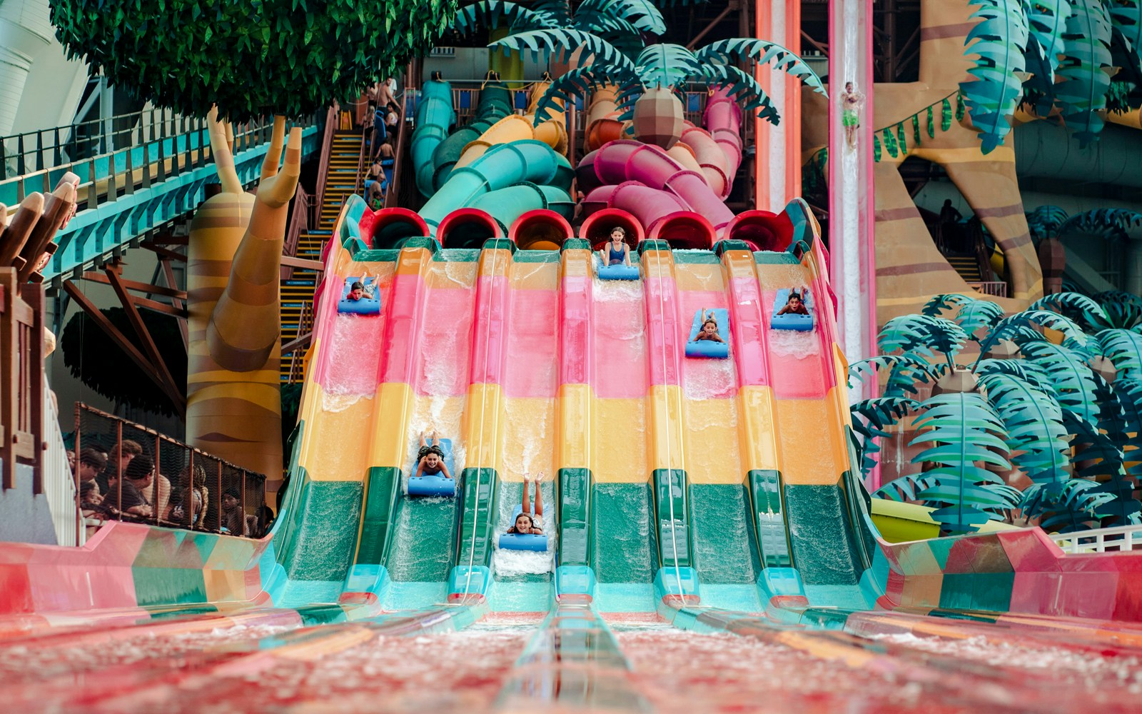 Guests enjoying the Trolls Rainbow Races ride at American Dream DreamWorks Water Park.