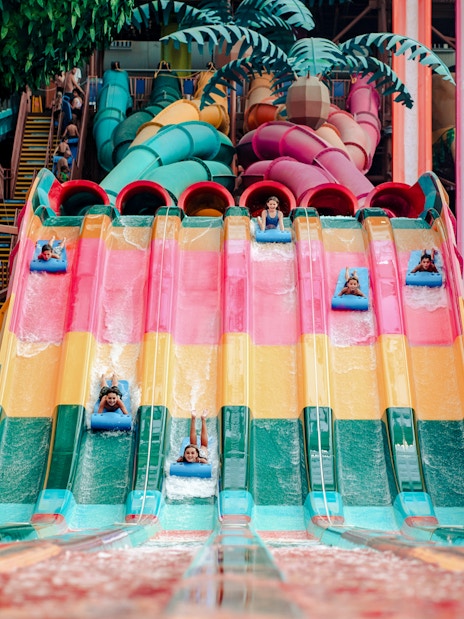 Guests enjoying the Trolls Rainbow Races ride at American Dream DreamWorks Water Park.