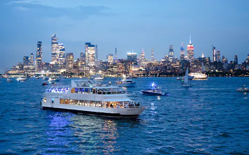 Cruise ship on New York City waters with skyline view during New Year's Eve.