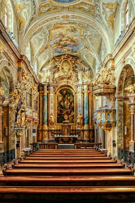 Interior of St Anne's Church with ornate arches and detailed frescoes.