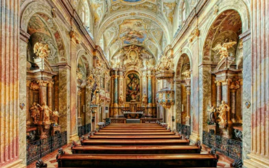 Interior of St Anne's Church with ornate arches and detailed frescoes.
