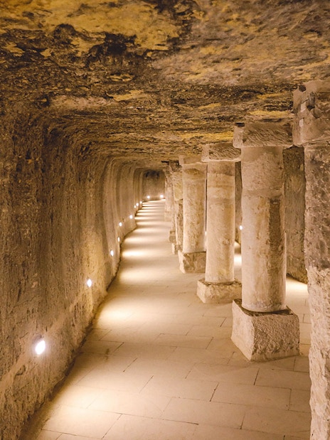 Ancient stone columns and brick walls inside the Step Pyramid of Djoser, Saqqara, Egypt.