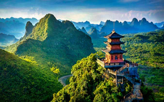 Pagoda overlooking lush mountains in Trang An Heritage, Vietnam.