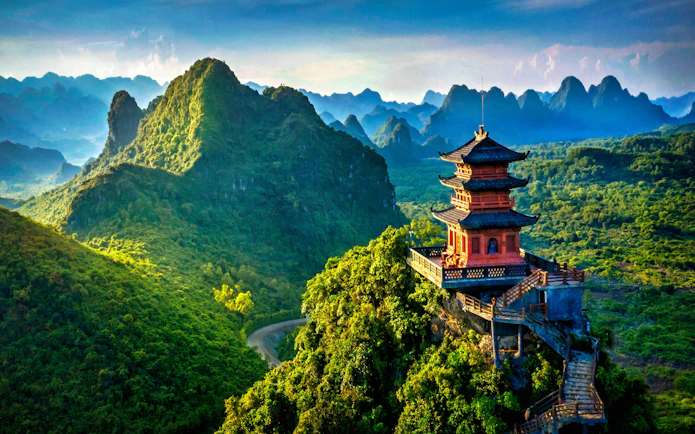 Pagoda overlooking lush mountains in Trang An Heritage, Vietnam.