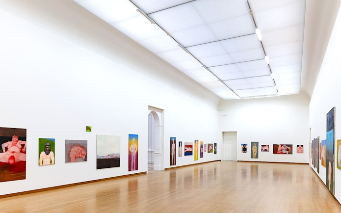 Installation view of Miriam Cahn's artwork at Stedelijk Museum, featuring colorful paintings on white walls.