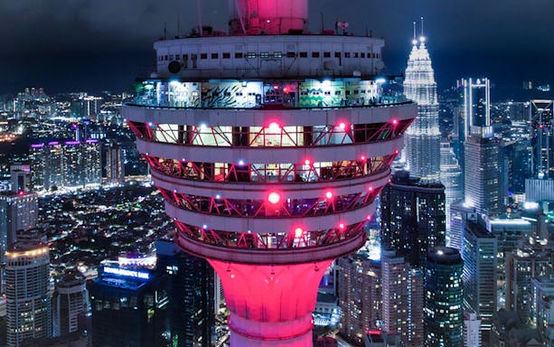 KL Tower illuminated at night during New Year Eve celebration in Kuala Lumpur.