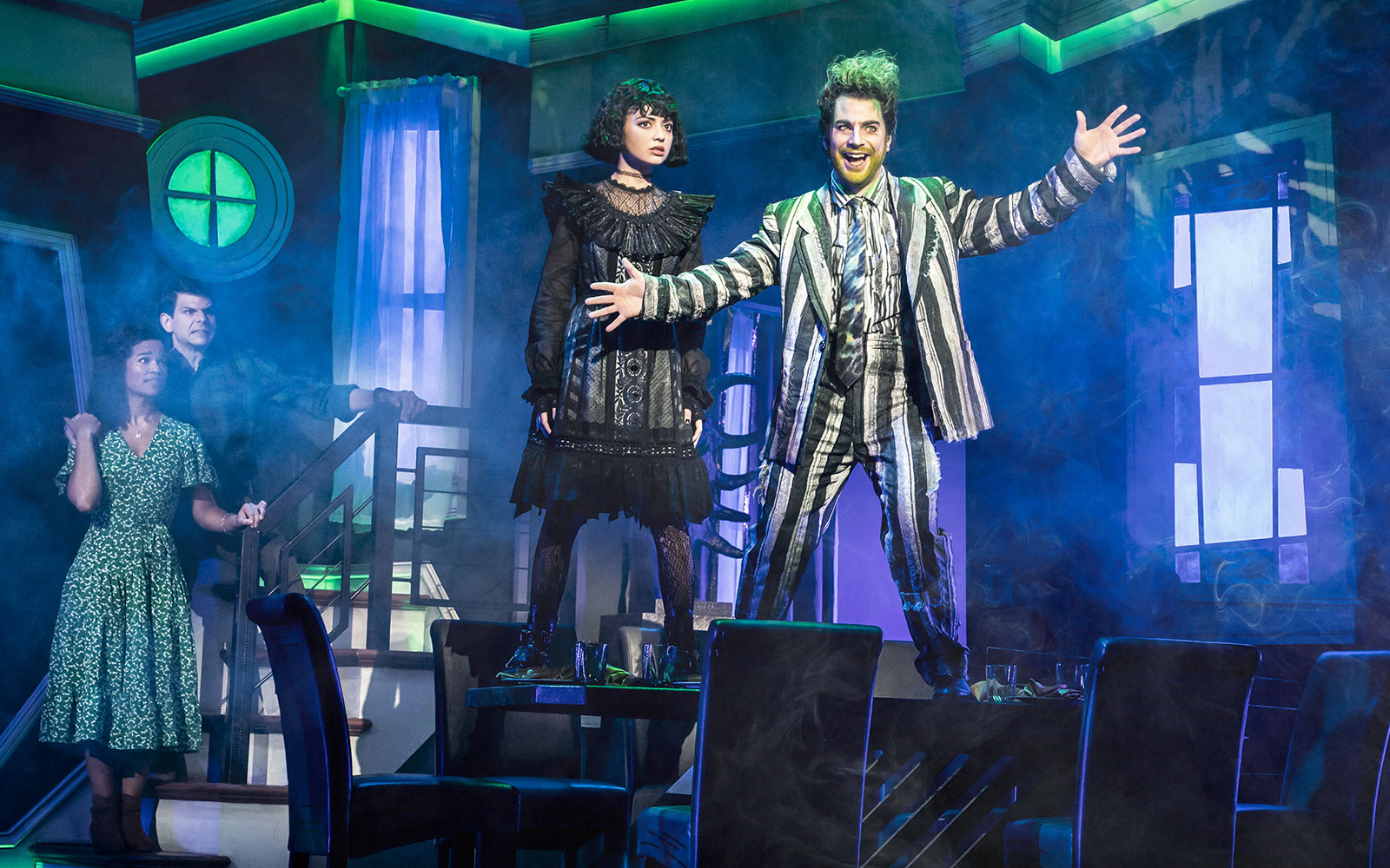 Stage scene from Beetlejuice West End with characters in dramatic poses.
