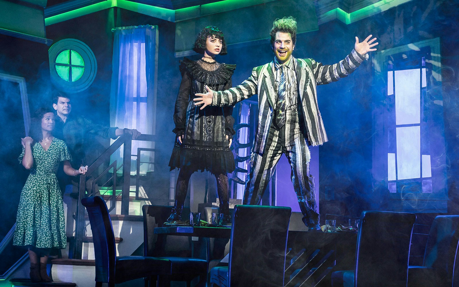 Stage scene from Beetlejuice West End with characters in dramatic poses.