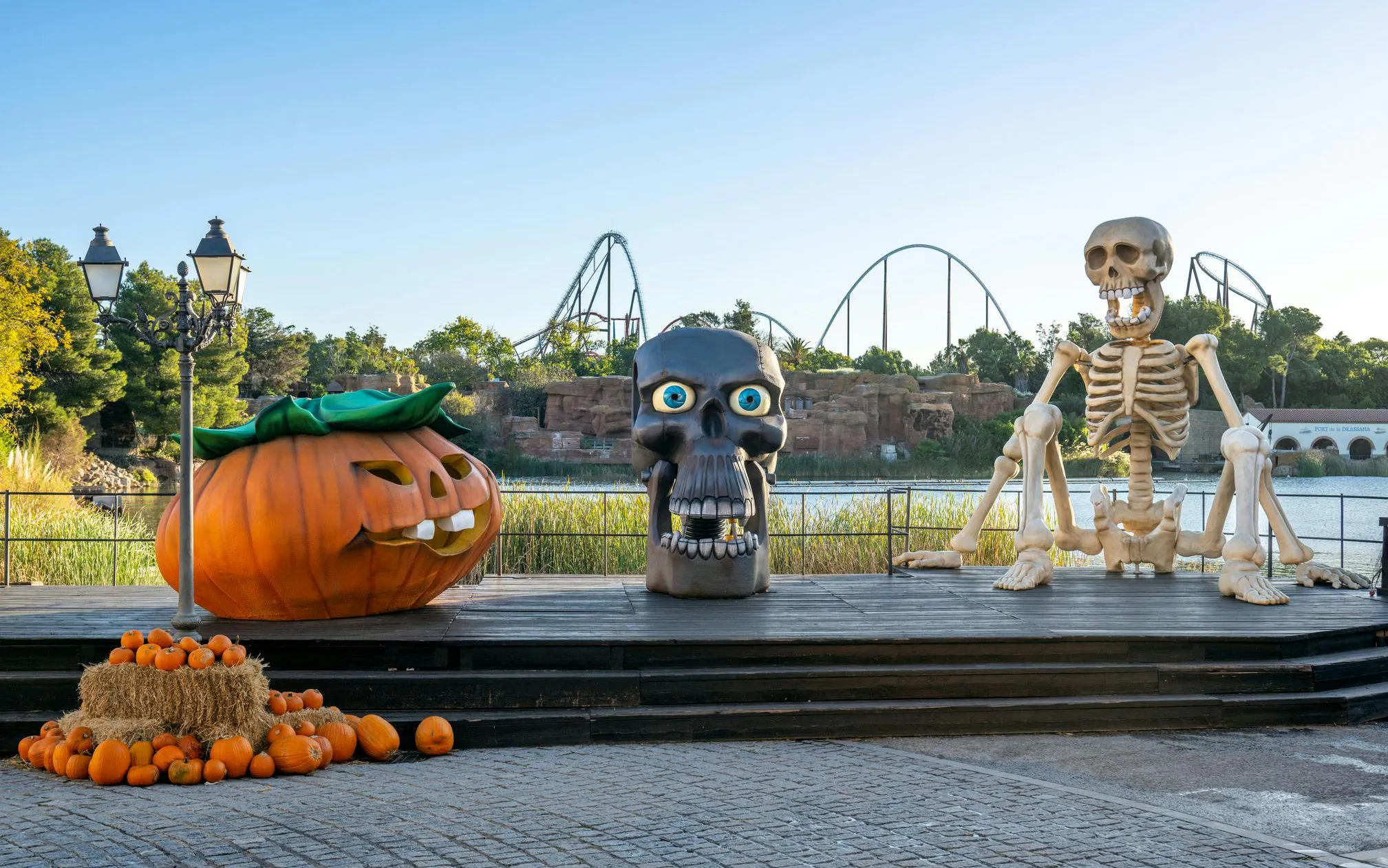 Halloween decorations with giant pumpkin and skeleton at PortAventura Park.