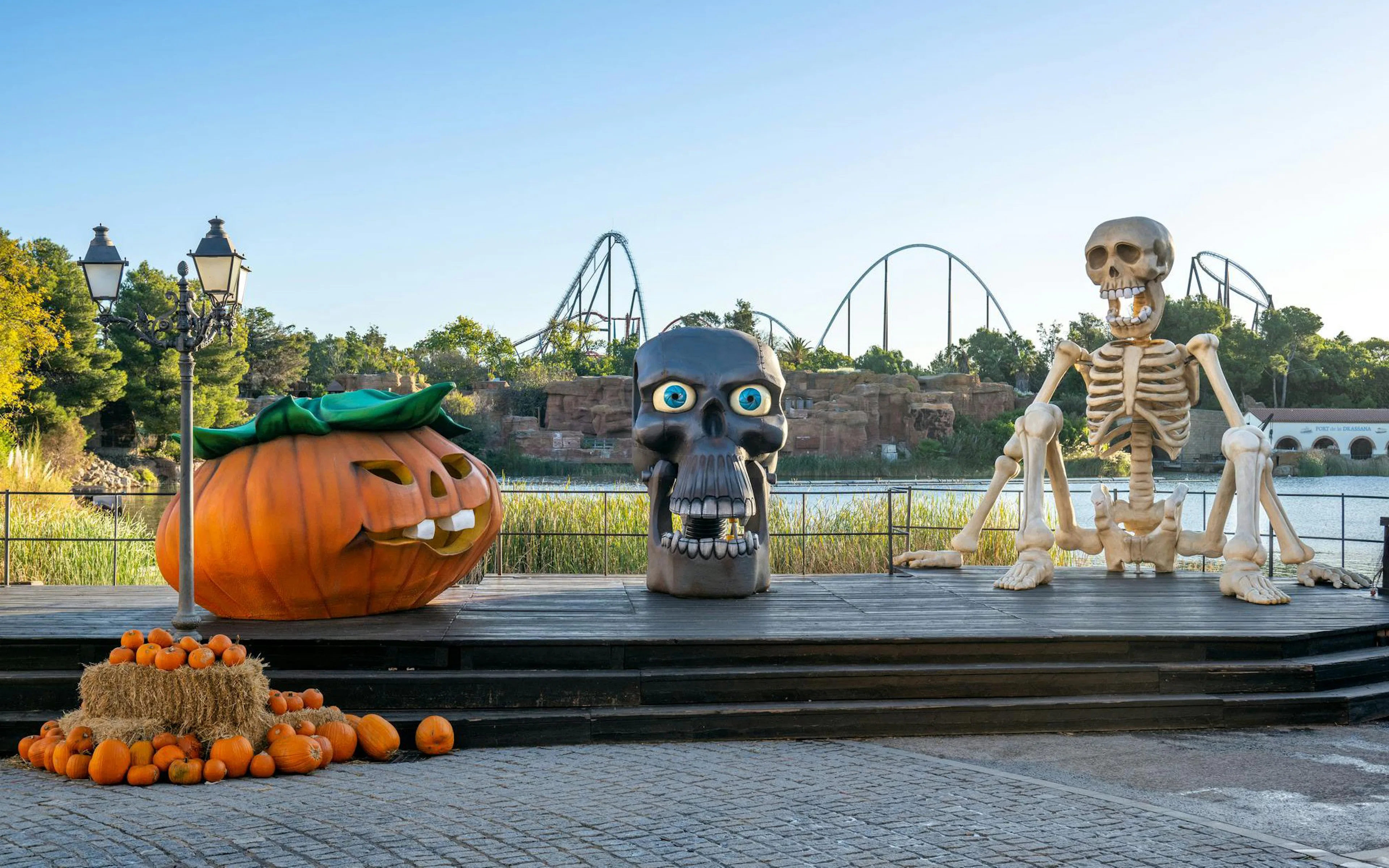 Halloween decorations with giant pumpkin and skeleton at PortAventura Park.