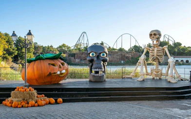 Halloween decorations with giant pumpkin and skeleton at PortAventura Park.