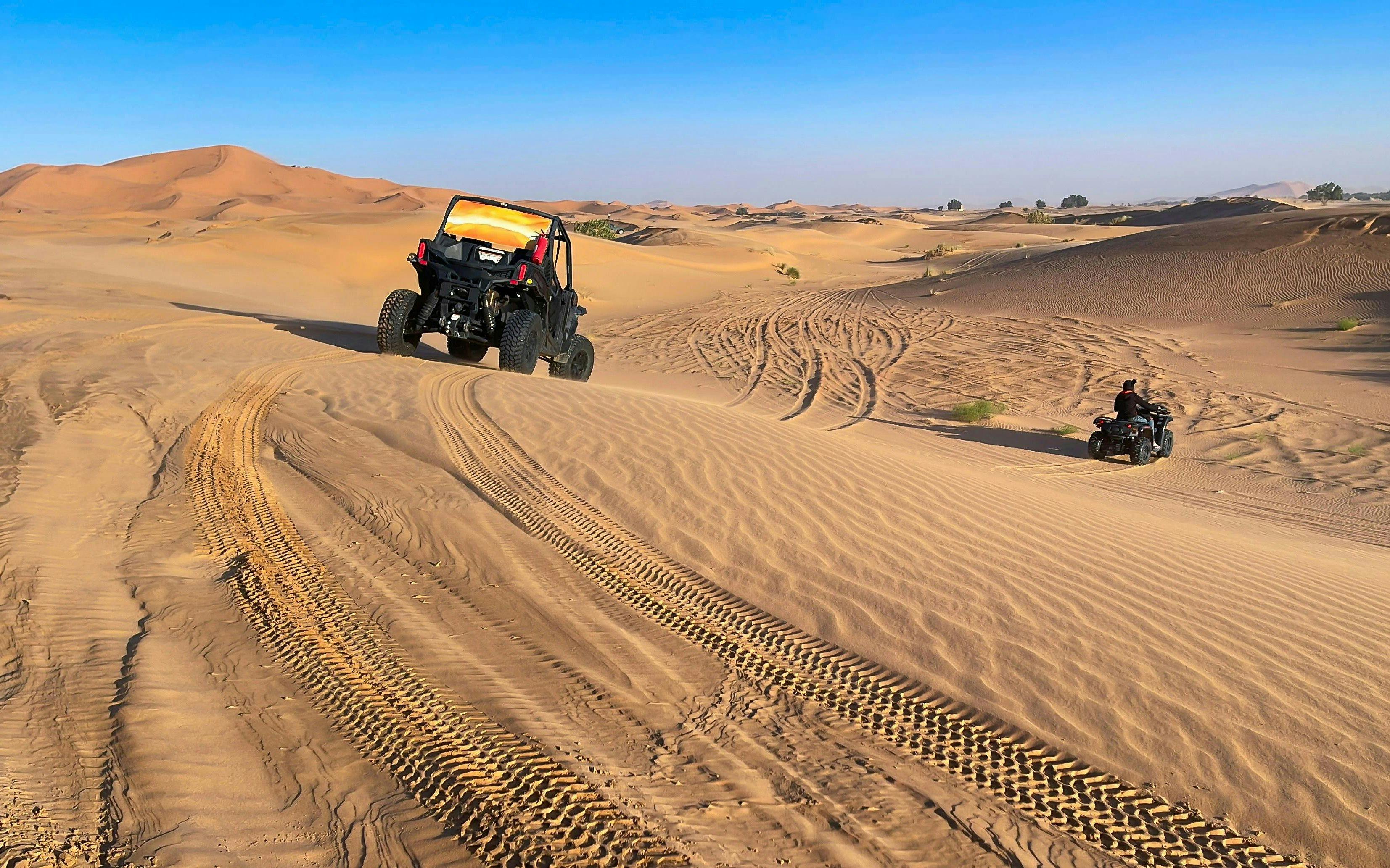 ATV riding on sand dunes in Erg Chebbi, Sahara Desert.