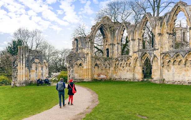 Visitors walking near medieval ruins on the Harry Potter Magical Guided Walking Tour in York.