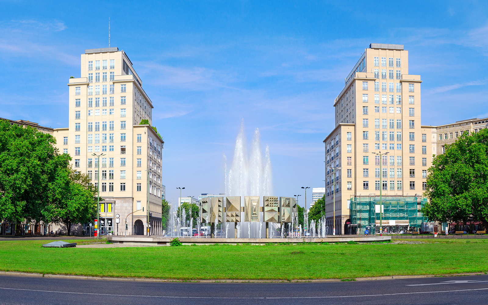 Berlin Karl-Marx-Allee with twin buildings and fountain on City Circle Hop-On Hop-Off Tour.