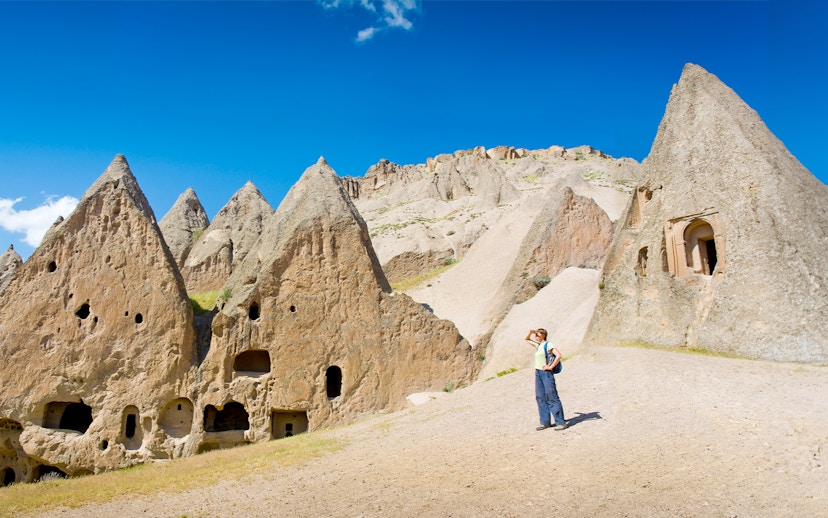Trekker exploring rock formations in Cappadocia during the Full-Day Green Tour.
