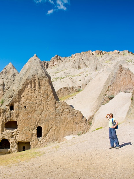 Trekker exploring rock formations in Cappadocia during the Full-Day Green Tour.