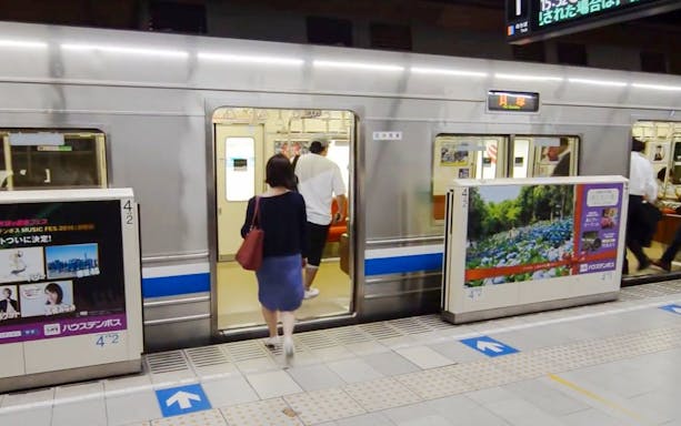 Passengers boarding a subway train in Fukuoka City station.