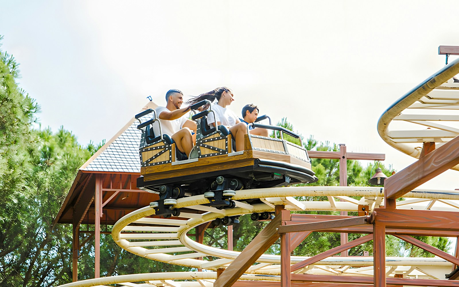 Parque de Atracciones de Madrid Vertigo ride with people experiencing thrilling loops and turns.