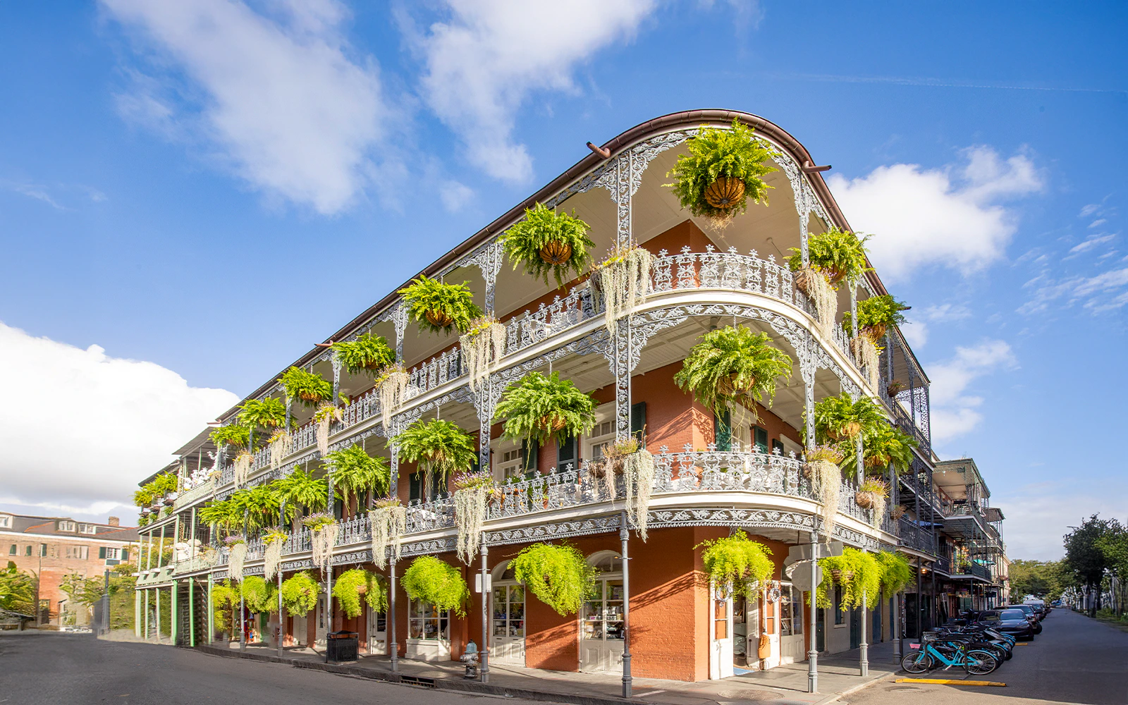 Historic building with wrought iron balconies and greenery in the French Quarter, New Orleans.